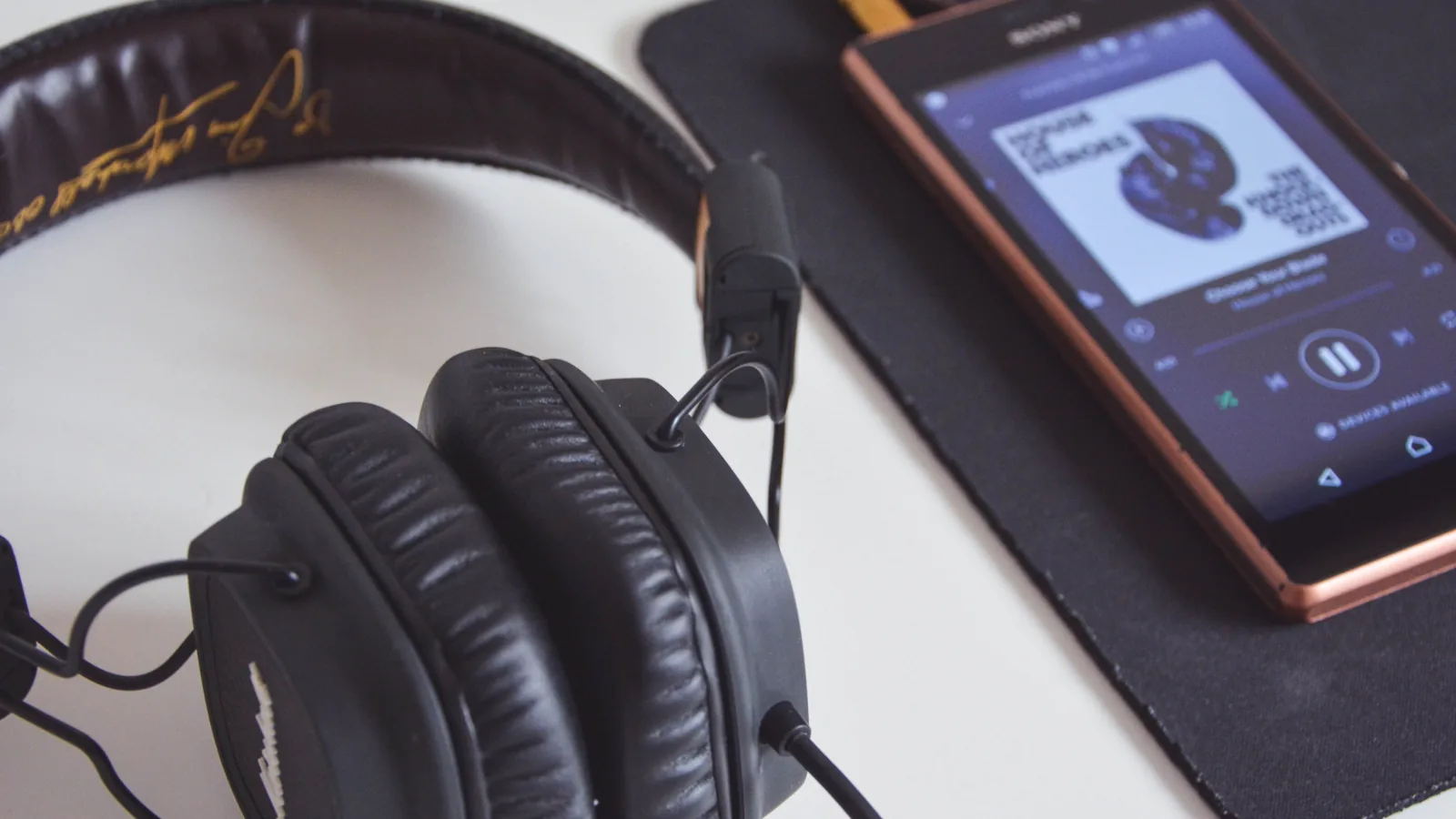 Headphones beside a portable music player before removing metadata from an MP3 file